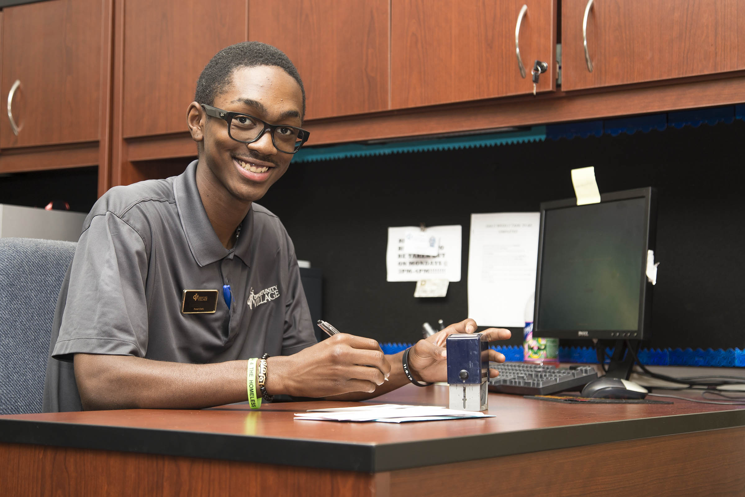 AbilityOne Man working at desk for AbilityOne program at Opportunity Village.