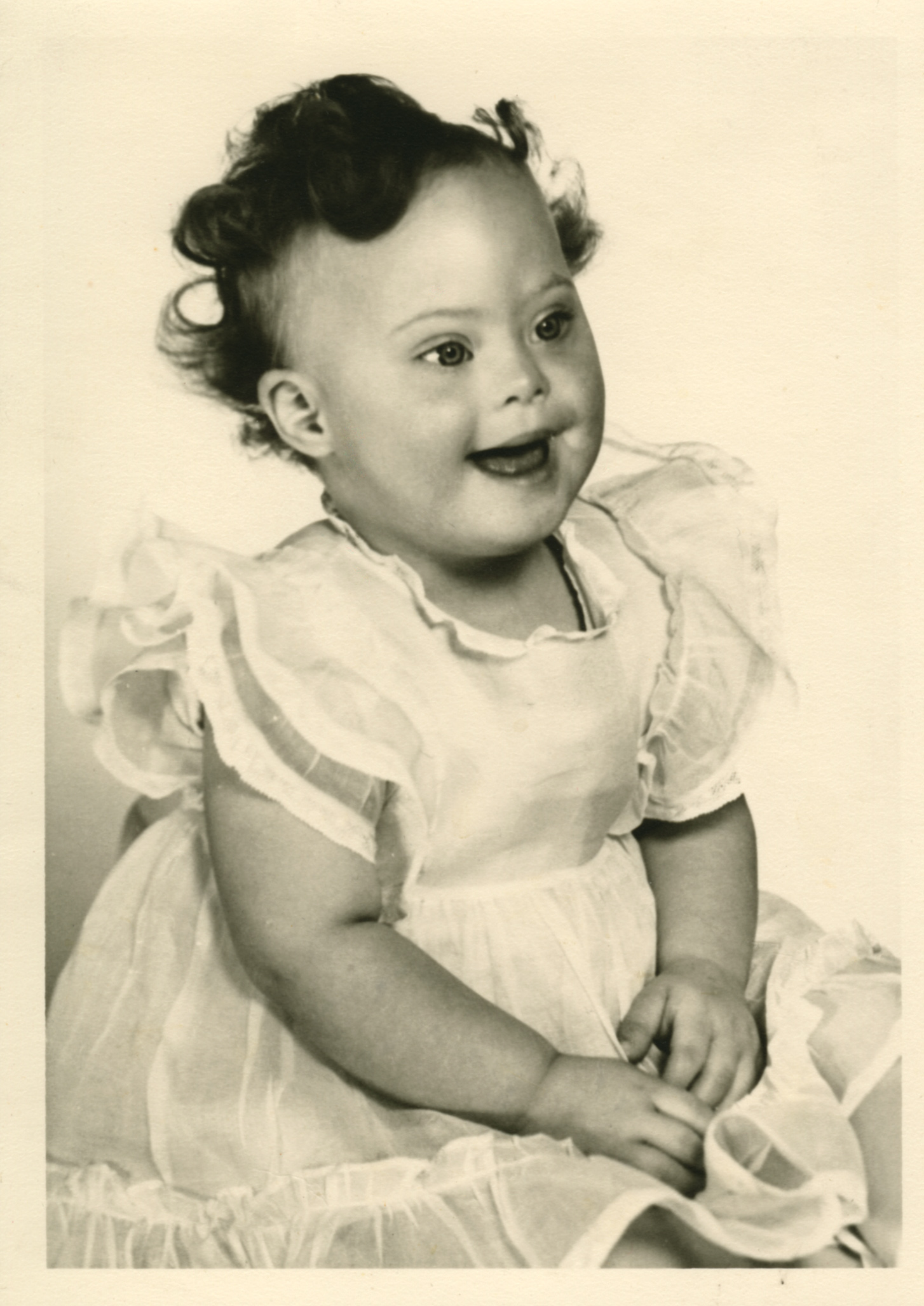 Young toddler smiling at the camera.