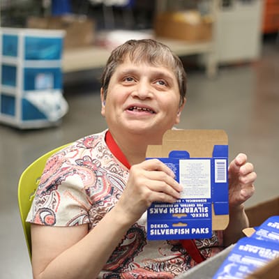 Woman participating in a disability services program at Opportunity Village.