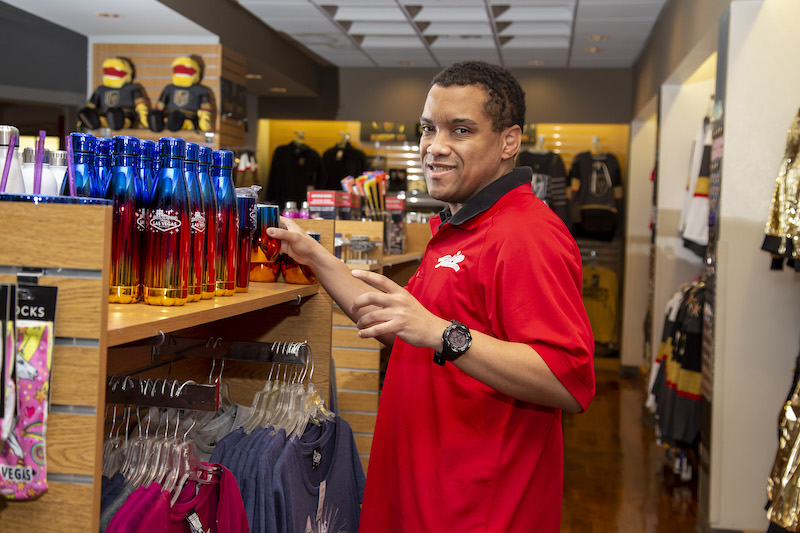 Person standing in front of a retail store display.