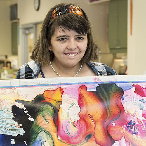 Woman holding a painting.