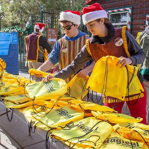 People volunteering at an event table.