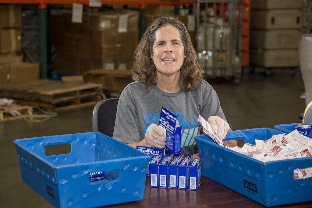 Woman assembling items together into a box.