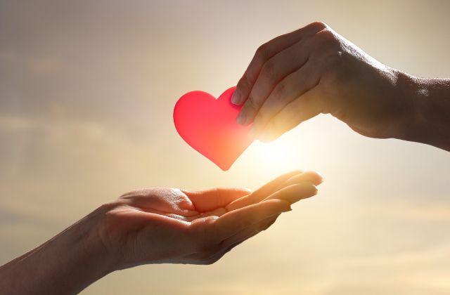 what-is-a-special-needs-trust – 1 Hand holding paper heart over another open hand.
