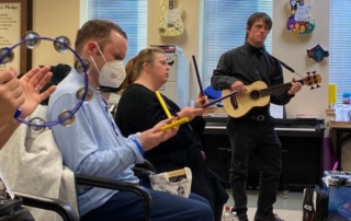 Group of adults playing musical instruments in a day program.