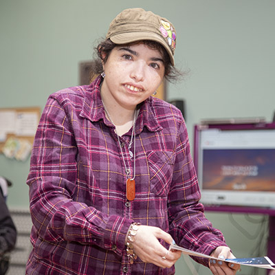 Women in purple shirt working at a day habilitation center in Las Vegas.