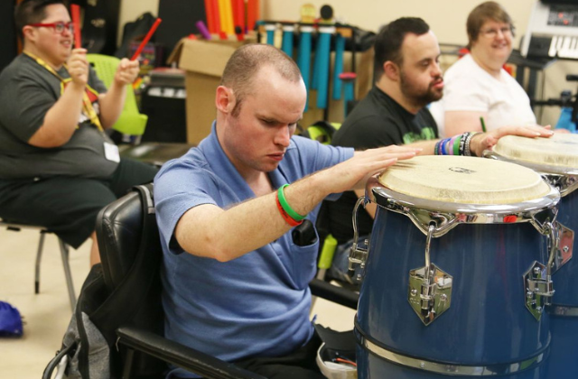 Adults playing musical instruments.