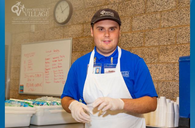 young man working in a commercial kitchen training for work