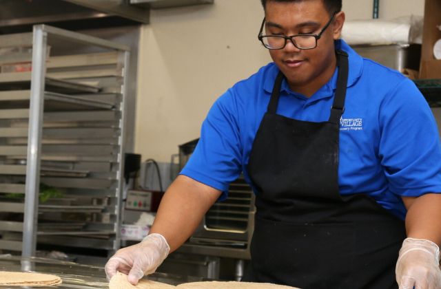 young student working in a commercial kitchen