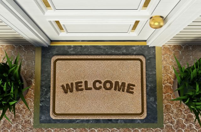 brown and green door mat with the text 'welcome'