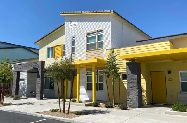 white townhome building with yellow trim