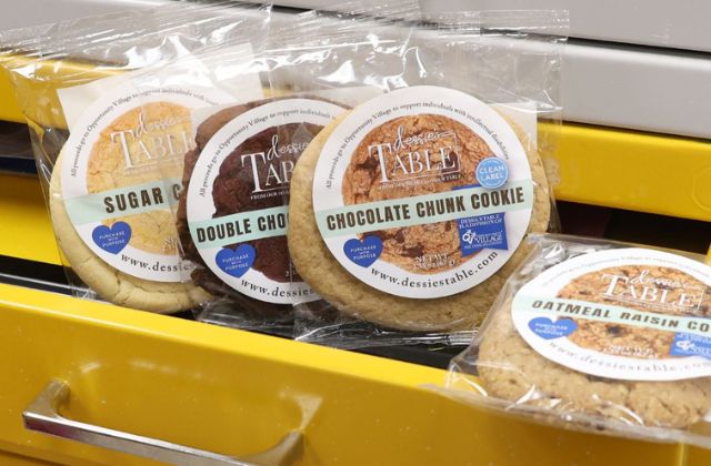 four individually wrapped cookies on a yellow cabinet