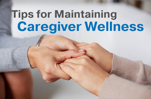 photo of four hands holding each other with the text 'tips for maintain caregiver wellness' printed above them