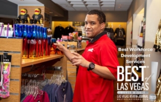 a person in a red shirt standing at a retail display shelf with the words 'best workforce development services, best of las vegas silver winner' on the image