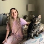 person and a cat sitting in a living room