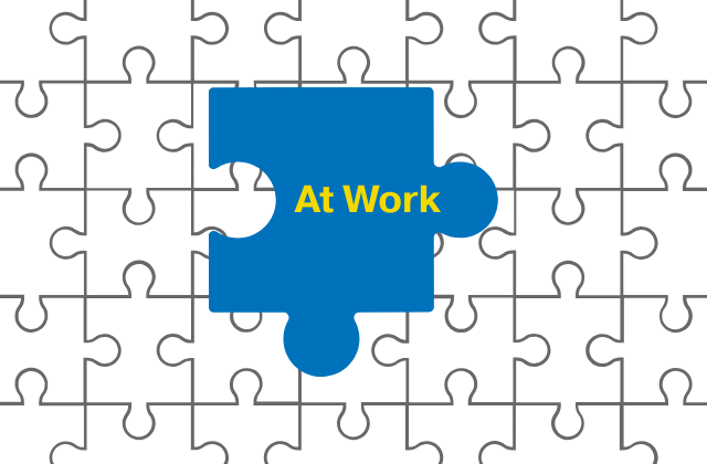 blue puzzle piece with the text 'at work' in the center