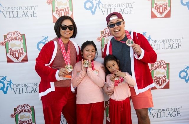 family dressed up for the 5k las vegas great santa run by opporunity village