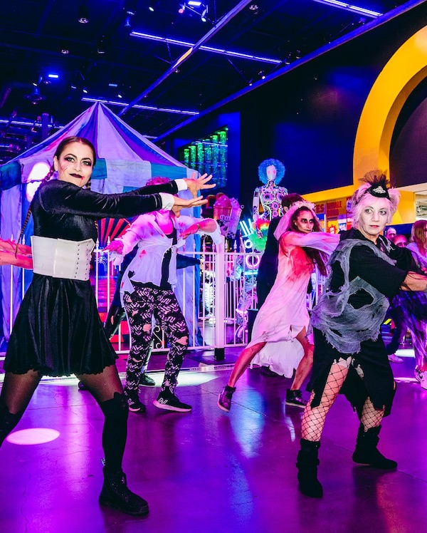 people wearing zombie costumes dancing at a club