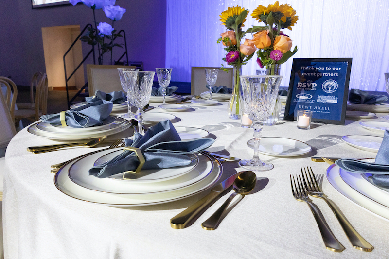 table setting with a vase of flowers at an event venue