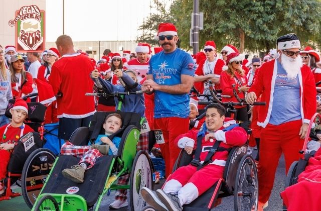 people in santa suits at a community race for charity